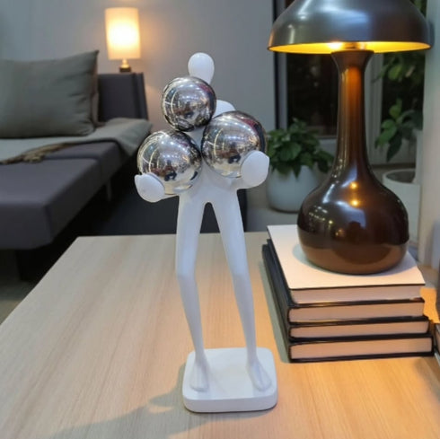 Human Figurine with Metallic Spheres