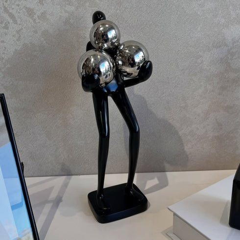 Human Figurine with Metallic Spheres